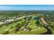 Aerial view showcasing lush golf course, picturesque ponds, and beautiful landscaping at 7461 W Country Club N Dr # 206, Sarasota, FL 34243