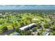 Aerial view of a community with a golf course, lakes, and lush landscaping at 7461 W Country Club N Dr # 206, Sarasota, FL 34243