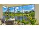 Relaxing screened balcony with picturesque views of the lush golf course and pond at 7461 W Country Club N Dr # 206, Sarasota, FL 34243