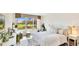 Cozy bedroom featuring scenic views of the golf course, lots of sunlight and golf course views at 7461 W Country Club N Dr # 206, Sarasota, FL 34243