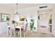 Cozy dining room with a white table, stylish chairs, and views of the front hallway at 7461 W Country Club N Dr # 206, Sarasota, FL 34243