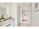 Bright hallway featuring tiled floors and ample storage space, and a mirror at 7461 W Country Club N Dr # 206, Sarasota, FL 34243