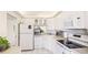 Clean, white kitchen with modern appliances, ample counter space, and natural light at 7461 W Country Club N Dr # 206, Sarasota, FL 34243