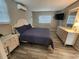 Cozy bedroom with sleek furniture, hardwood floors, and a bright window creating a relaxing living space at 7511 1St W Ave, Bradenton, FL 34209