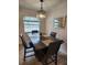 Cozy dining room featuring a dark wood table, a decorative chandelier, and natural light from a nearby window at 7511 1St W Ave, Bradenton, FL 34209