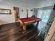 Game room with a pool table, hardwood floors, and natural light, ideal for entertaining and recreation at 7511 1St W Ave, Bradenton, FL 34209