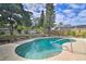A refreshing swimming pool with a backyard surrounded by lush greenery and a well-maintained fence at 7511 1St W Ave, Bradenton, FL 34209