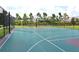 Community sports park featuring fenced basketball court and mature evergreens at 7915 115Th E Ave, Parrish, FL 34219
