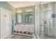 Bright bathroom featuring a double vanity with marble countertop and a walk-in shower with glass enclosure and tile surround at 7915 115Th E Ave, Parrish, FL 34219