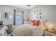 Cozy bedroom features neutral decor, a comfortable bed, modern window treatments, and decorative wall art at 7915 115Th E Ave, Parrish, FL 34219