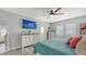 Bedroom featuring a comfortable bed, dresser, ceiling fan, and a wall-mounted TV showcasing a scenic view at 7915 115Th E Ave, Parrish, FL 34219