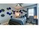 Bright bedroom featuring unique wall decor, a comfortable bed, and a dedicated workspace at 7915 115Th E Ave, Parrish, FL 34219