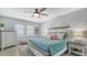 Bedroom featuring a comfortable bed, a dresser, and a ceiling fan for added comfort at 7915 115Th E Ave, Parrish, FL 34219