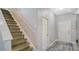 Bright entryway with a staircase leading to the second floor and a white front door with a blue rug at 7915 115Th E Ave, Parrish, FL 34219