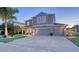 Lovely two-story home featuring a well-manicured lawn, a three-car garage, and a welcoming front porch at 7915 115Th E Ave, Parrish, FL 34219