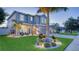 Gorgeous two-story home featuring a well-manicured lawn, a three-car garage, and a welcoming front porch at 7915 115Th E Ave, Parrish, FL 34219