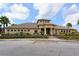 Well-maintained building exterior with manicured landscaping, palm trees, and a convenient circular driveway at 7915 115Th E Ave, Parrish, FL 34219