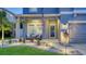 Cozy front porch with seating area, decorative plants, and stylish outdoor lighting at 7915 115Th E Ave, Parrish, FL 34219