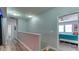 Hallway with wood floors, leading to a bedroom with a ceiling fan and natural light at 7915 115Th E Ave, Parrish, FL 34219