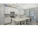 Modern kitchen with white cabinetry, stainless steel appliances, granite countertops, and bar seating at 7915 115Th E Ave, Parrish, FL 34219