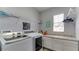 Functional laundry room with modern washer and dryer, ample counter space, and overhead shelving for organized storage at 7915 115Th E Ave, Parrish, FL 34219