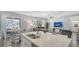 Bright living area with granite island, view of the pool, and a comfortable seating area at 7915 115Th E Ave, Parrish, FL 34219
