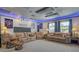 Comfortable media room with multiple seating options, a large screen, and ambient lighting for an enhanced cinematic experience at 7915 115Th E Ave, Parrish, FL 34219