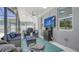 Inviting covered patio area with grill, comfortable seating, ceiling fan and stylish decor at 7915 115Th E Ave, Parrish, FL 34219