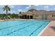 Large community pool with clear blue water, lounge chairs, and poolside pavilion at 7915 115Th E Ave, Parrish, FL 34219