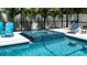 Beautiful in-ground pool features a relaxing spa, poolside seating, and a screened-in patio area at 7915 115Th E Ave, Parrish, FL 34219