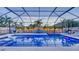 Relaxing screened-in pool area with comfortable lounge seating, hot tub, and swaying palm trees at 7915 115Th E Ave, Parrish, FL 34219