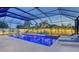 Beautiful screened pool area with lounge chairs, hot tub, and tropical landscaping at 7915 115Th E Ave, Parrish, FL 34219