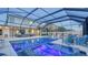 Stunning pool with a screened enclosure featuring a hot tub and a covered outdoor living area at 7915 115Th E Ave, Parrish, FL 34219