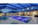 Resort-style screened-in pool and patio area featuring multiple seating areas, a grill, and lush landscaping, ideal for outdoor living at 7915 115Th E Ave, Parrish, FL 34219