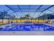 Beautiful screened pool area with comfortable seating, a luxurious hot tub, and swaying palm trees at 7915 115Th E Ave, Parrish, FL 34219