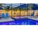Inviting screened pool area featuring a hot tub, poolside chairs, and lush tropical landscaping at 7915 115Th E Ave, Parrish, FL 34219
