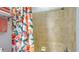 Shower features peach shower curtain and beige tiled walls, with a mounted shower head and soap dish at 7915 115Th E Ave, Parrish, FL 34219