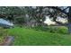 Spacious backyard with mature trees and green grass at 7915 Kavanagh Ct, Sarasota, FL 34240