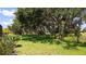Lush backyard with mature trees, offering shade and privacy at 7915 Kavanagh Ct, Sarasota, FL 34240