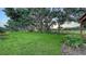 Expansive backyard featuring lush green grass and mature trees at 7915 Kavanagh Ct, Sarasota, FL 34240