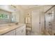 Bathroom with glass shower, marble countertops, and neutral colors at 7915 Kavanagh Ct, Sarasota, FL 34240