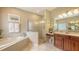 Spacious bathroom featuring a soaking tub, glass-enclosed shower, and double vanity at 7915 Kavanagh Ct, Sarasota, FL 34240
