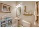 Cozy half-bath featuring blue cabinet, framed artwork, and an octagonal mirror at 7915 Kavanagh Ct, Sarasota, FL 34240