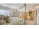 A sunlit main bedroom boasts a canopy bed and access to the sitting room at 7915 Kavanagh Ct, Sarasota, FL 34240