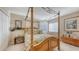 Comfortable bedroom featuring a canopy bed, natural light, and wood accents at 7915 Kavanagh Ct, Sarasota, FL 34240