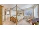 Relaxing bedroom featuring a canopy bed, natural lighting, and closet access at 7915 Kavanagh Ct, Sarasota, FL 34240
