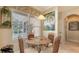 Breakfast nook with a glass table and four chairs near a large window with exterior views at 7915 Kavanagh Ct, Sarasota, FL 34240