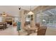 Cozy breakfast nook with four chairs beside a large window near the living and outdoor space at 7915 Kavanagh Ct, Sarasota, FL 34240