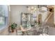 Elegant dining room featuring chandelier lighting with ornate decor and staircase at 7915 Kavanagh Ct, Sarasota, FL 34240
