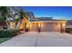 Charming two-story home with a well-manicured lawn, mature trees, and a spacious driveway leading to a two-car garage at 7915 Kavanagh Ct, Sarasota, FL 34240
